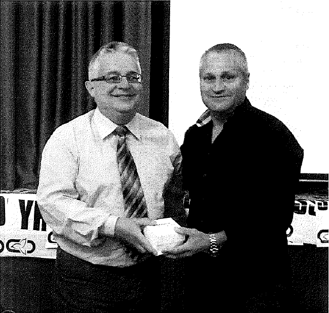 John Nador receiving his award from Victor Mendes